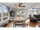 Bright dining room with wood floors, ceiling fan, large window, and view to living area at 405 Miller Rd, Covington, GA 30014