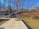 Well-maintained dock with seating, providing direct access to the lake and surrounding wooded landscape at 405 Miller Rd, Covington, GA 30014