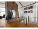 A stylish foyer featuring wood floors, a brick accent wall, and an adjacent living area at 405 Miller Rd, Covington, GA 30014