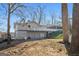 The house has a large, light colored deck, and a covered parking area on the other side at 405 Miller Rd, Covington, GA 30014