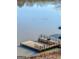 Scenic lake view featuring dual docks and serene water, enhanced by natural light and wildlife at 405 Miller Rd, Covington, GA 30014