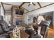 Open concept living room featuring a brick fireplace, leather sofas, and hardwood floors at 405 Miller Rd, Covington, GA 30014