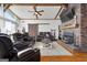 Living room featuring a fireplace, hardwood floors, comfortable furniture and wood beam ceiling at 405 Miller Rd, Covington, GA 30014