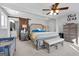 Spacious main bedroom with rustic sliding door, ceiling fan, and soft carpet at 405 Miller Rd, Covington, GA 30014