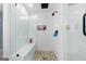 Modern tiled shower with built in seat, shower niche, decorative floor, and glass surround at 405 Miller Rd, Covington, GA 30014