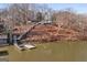 Scenic waterfront view featuring a dock and stairway to a house on a wooded hillside at 405 Miller Rd, Covington, GA 30014