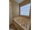 Soaking tub with a faucet and window view in the bathroom at 3081 Regal Dr, Mcdonough, GA 30253