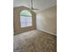 Bedroom featuring vaulted ceiling, ceiling fan, and large arched window at 3081 Regal Dr, Mcdonough, GA 30253