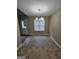 The dining room has vinyl flooring, a chandelier, a window, and access to the backyard at 3081 Regal Dr, Mcdonough, GA 30253