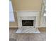 Close-up of the fireplace showcasing the elegant white mantle and marble surround at 3081 Regal Dr, Mcdonough, GA 30253