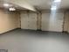Garage showcasing two garage doors and epoxy flooring at 3081 Regal Dr, Mcdonough, GA 30253