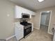Kitchen with stainless steel appliances, a gas range, white cabinets, and tile flooring at 3081 Regal Dr, Mcdonough, GA 30253