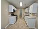 Well-lit kitchen with white cabinets, stainless steel appliances, and tile flooring at 3081 Regal Dr, Mcdonough, GA 30253