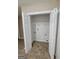 Laundry room with tile flooring, bi-fold doors, and washer/dryer hookups at 3081 Regal Dr, Mcdonough, GA 30253