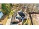 Aerial shot of brick home with attached garage, surrounded by trees and manicured lawn at 418 Crosshaven Way, Mcdonough, GA 30253