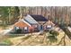 An attractive brick home with an arched entryway, classic shutters, and a well-manicured lawn nestled among mature trees at 418 Crosshaven Way, Mcdonough, GA 30253