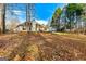 Expansive backyard featuring a brick fire pit and home in background at 418 Crosshaven Way, Mcdonough, GA 30253