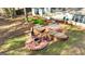 Backyard with a multi-tiered patio featuring a fire pit, seating, and an outdoor grilling area at 418 Crosshaven Way, Mcdonough, GA 30253