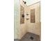 Updated shower with multiple shower heads, decorative tile accents, and glass block window at 418 Crosshaven Way, Mcdonough, GA 30253