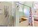 Full bath features a deep soaking tub, shower, and frosted glass for privacy at 418 Crosshaven Way, Mcdonough, GA 30253