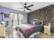 Bedroom with floral wallpaper, plush carpeting, ceiling fan, and a decorative patterned bed at 418 Crosshaven Way, Mcdonough, GA 30253