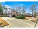 Long driveway leading to a brick home, featuring well-maintained landscaping and a two-car garage at 418 Crosshaven Way, Mcdonough, GA 30253