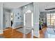 Bright foyer with hardwood floors and detailed molding with view of the living room at 418 Crosshaven Way, Mcdonough, GA 30253