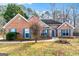Charming brick home featuring blue shutters, a landscaped front yard, and a welcoming entrance at 418 Crosshaven Way, Mcdonough, GA 30253