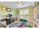 Home office with built-in shelving, decorative rug, and large window offering natural light at 418 Crosshaven Way, Mcdonough, GA 30253
