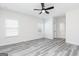 The bright bedroom features luxury vinyl flooring and a modern ceiling fan at 3744 Saddle Bag Ct, Dacula, GA 30019