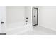Bathroom features tub and shower with black hardware and tiled walls at 3382 Arabian Farm Ln, Dacula, GA 30019