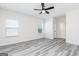 Spacious bedroom with gray flooring, white walls, windows, and ceiling fan at 3382 Arabian Farm Ln, Dacula, GA 30019