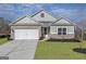 Charming one-story home with brick and gray siding, well-manicured lawn, and a two-car garage at 3382 Arabian Farm Ln, Dacula, GA 30019