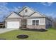 Charming one-story home with brick and gray siding, well-manicured lawn, and a two-car garage at 3382 Arabian Farm Ln, Dacula, GA 30019