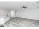 Spacious living area with gray flooring, a kitchen island, and an open layout with easy access to other rooms at 3382 Arabian Farm Ln, Dacula, GA 30019