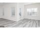 Living room with multiple windows providing natural light and featuring gray flooring, and a rear glass door at 3382 Arabian Farm Ln, Dacula, GA 30019