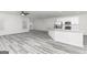 Open-concept living space featuring gray flooring, a kitchen island, and plenty of natural light from windows at 3382 Arabian Farm Ln, Dacula, GA 30019