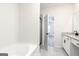 Bathroom features tub and shower combo with open doorway between bedroom and bathroom at 3734 Saddle Bag Ct, Dacula, GA 30019