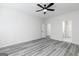 Bright bedroom with ceiling fan, wood-look floors, and adjoining doorway at 3734 Saddle Bag Ct, Dacula, GA 30019