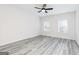 Spacious bedroom featuring a ceiling fan, two windows, and modern wood-look flooring at 3734 Saddle Bag Ct, Dacula, GA 30019