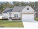 Charming single-Gathering home boasting a brick and siding facade, manicured lawn, and attached two-car garage at 3734 Saddle Bag Ct, Dacula, GA 30019