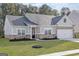 Inviting home showcasing a well-maintained front yard and a classic mix of siding and brick architectural details at 3734 Saddle Bag Ct, Dacula, GA 30019