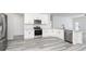 Modern kitchen with white cabinets, stainless steel appliances, and granite countertops at 3734 Saddle Bag Ct, Dacula, GA 30019