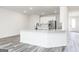 Bright, open kitchen featuring a large island, stainless steel appliances, and sleek white cabinetry at 3734 Saddle Bag Ct, Dacula, GA 30019
