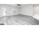 Open-concept living area with modern flooring, large windows, and a seamless flow to the kitchen and outdoor spaces at 3734 Saddle Bag Ct, Dacula, GA 30019
