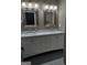Bright bathroom featuring a marble double vanity with updated fixtures and undermount sinks at 57 Deer Creek Run, Moreland, GA 30259