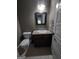 Cozy bathroom with dark wood vanity and a granite countertop, as well as a toilet and sink at 57 Deer Creek Run, Moreland, GA 30259