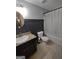 A bathroom with a vanity with granite countertop, modern sink, toilet and a shower tub combination at 57 Deer Creek Run, Moreland, GA 30259