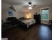 Large bedroom featuring a window, ceiling fan, and hardwood floors at 57 Deer Creek Run, Moreland, GA 30259