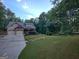 House exterior featuring a long driveway and well manicured lawn at 57 Deer Creek Run, Moreland, GA 30259